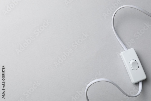 Canvastavla Cord switch for lamp on light grey background, top view