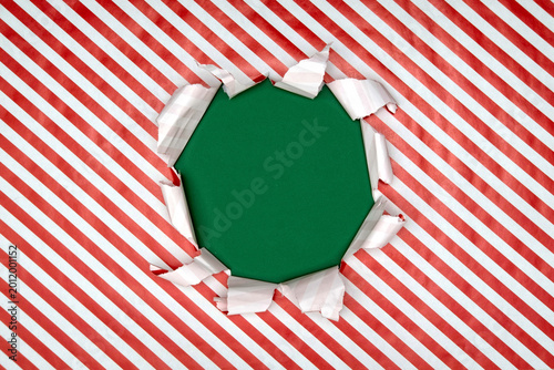 Gift wrapping paper tears from the center on a green background. Layout for discounts, text, etc