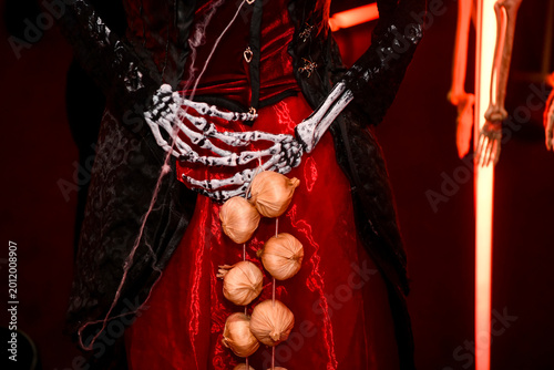 The atmospheric photography from the Halloween-themed event features a dramatic Halloween-inspired set, framed by spooky costumes, faux spider webs and mystical red lighting.