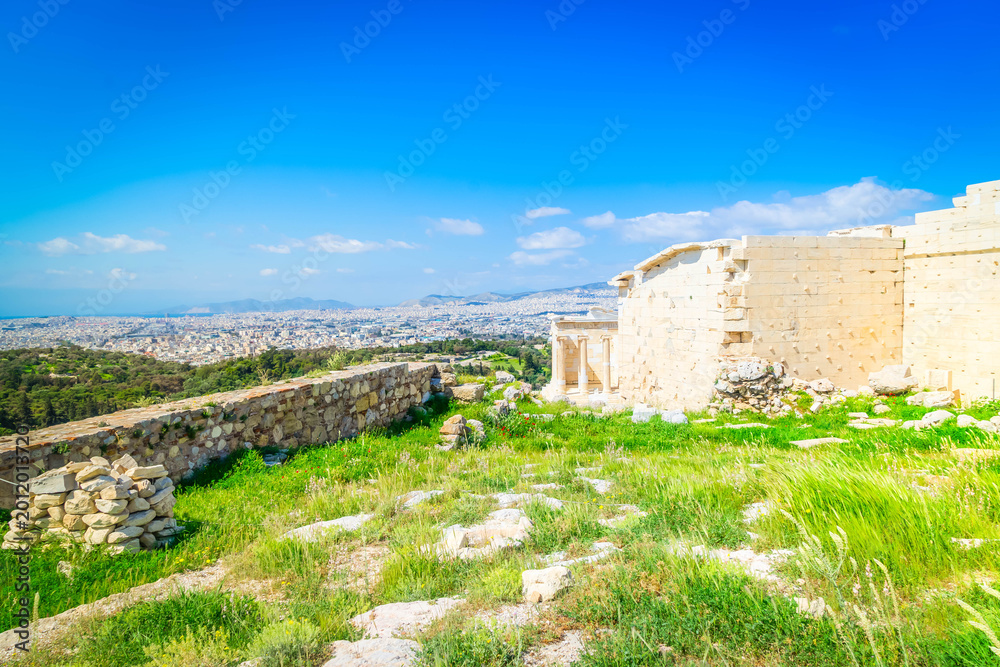 Fototapeta premium Erechtheion temple with green grass in Acropolis of Athens, Greece