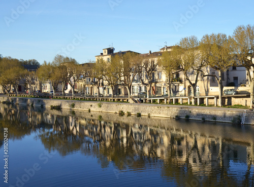 Scenic riverfront promenade in Sommières, France
