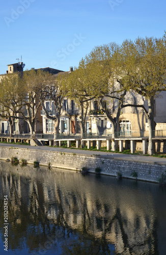 Scenic riverfront promenade in Sommières, France