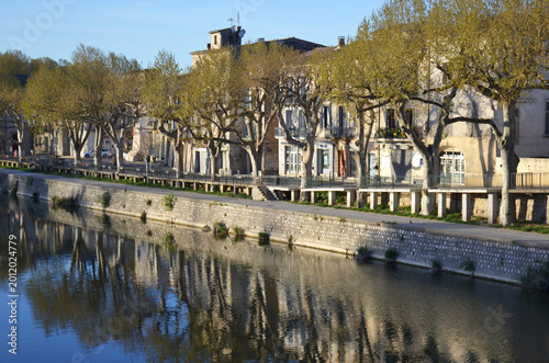 Scenic riverfront promenade in Sommières, France