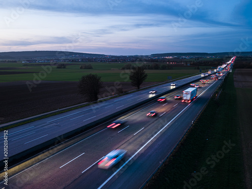 Aerial view of highway traffic traveling trough the countryside at night
