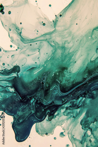A close-up of a blue and green chemical solution with bubbles vertical frame