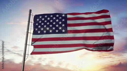 The American flag flying high against a vibrant sunrise sky with clouds.