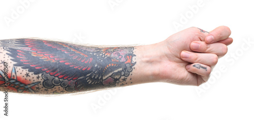 Fotografía Man with tattoos showing fig gesture on white background, closeup
