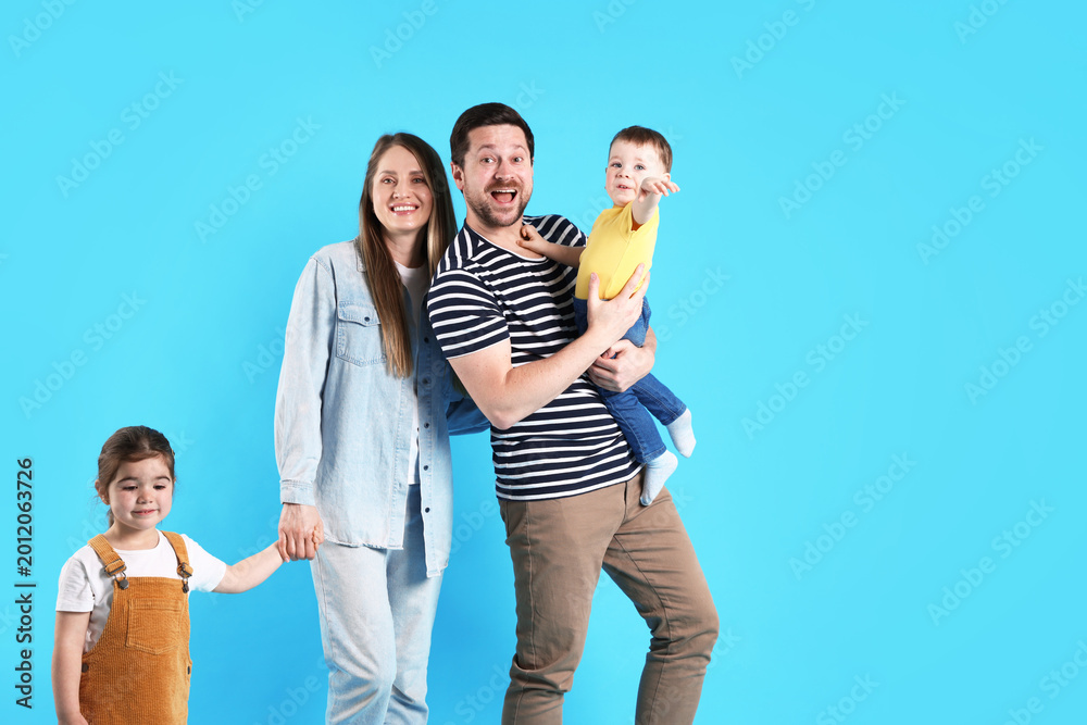Fototapeta premium Portrait of happy family on light blue background, space for text