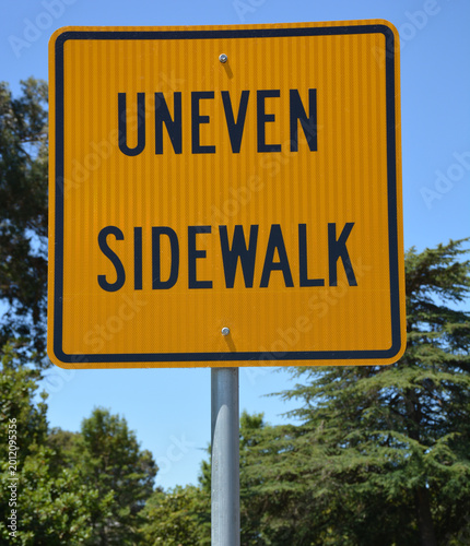 Street Sign Uneven Sidewalk