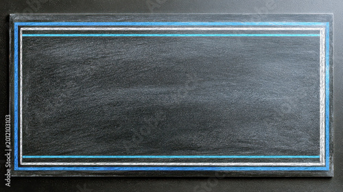 Empty rectangle frame drawn with chalk in white and blue colors on a blackboard background ready for creative text or artwork placement