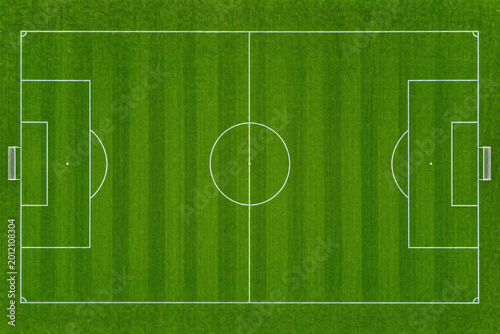 Vászonkép Aerial view of a green soccer field with white markings and mowed grass stripes,