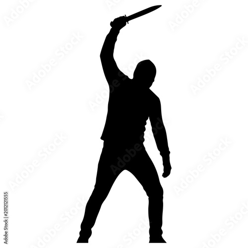 Fotografie Silhouette of a person holding a knife raised high.