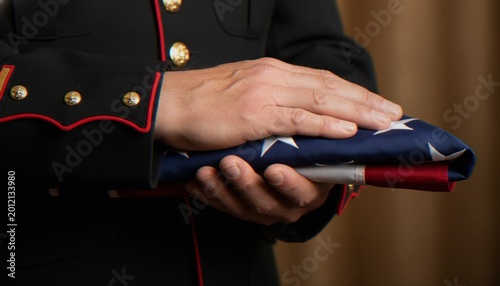 Bild auf Leinwand A close-up view of a United States Marine in dress blues holding a folded American flag during a somber military ceremony