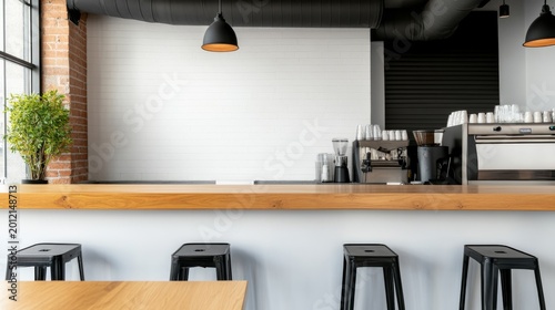 Modern minimalist cafe interior with a long wooden bar, black stools and an equipped espresso station. Bright white brick wall and industrial ceiling offer a clean, empty design