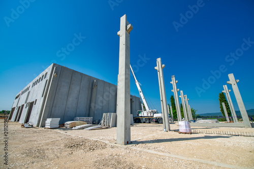 Fotografía Construction site details showing stacked materials, steel structures, and ongoi