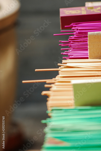 Bilde på lerret Colorful incense sticks neatly arranged for religious purposes