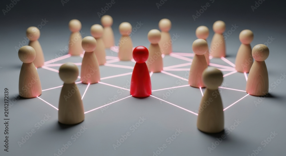 Obraz premium Network Leadership: Red Figure Stands Out Amongst Wooden Group, Connection and Hierarchy, Teamwork Concept, Organizational Structure