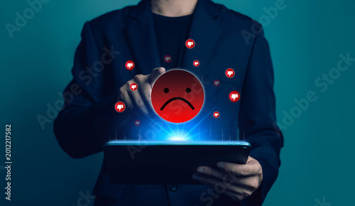 Negative customer experience and online dislike feedback concept with sad face icon and dislike symbols above tablet, poor service review, client dissatisfaction and bad user satisfaction rating