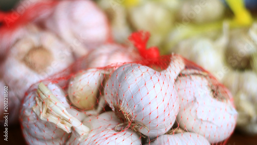 Garlic is packed in red mesh bags.