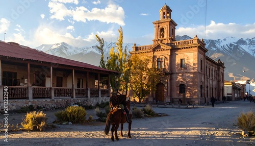 A scenic village square framed by a historic building and a traditional structure, with a rider on horseback in focus