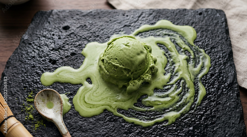 Obraz premium Artisanal matcha green tea ice cream softening on dark bowl premium dessert photography with rich textures