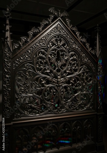Dark gothic architectural screen features intricate wood carvings of bats and ornate foliage designs.