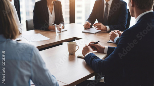Bild auf Leinwand Diverse group of business professionals engaging in a corporate meeting, collaborating around a modern conference table