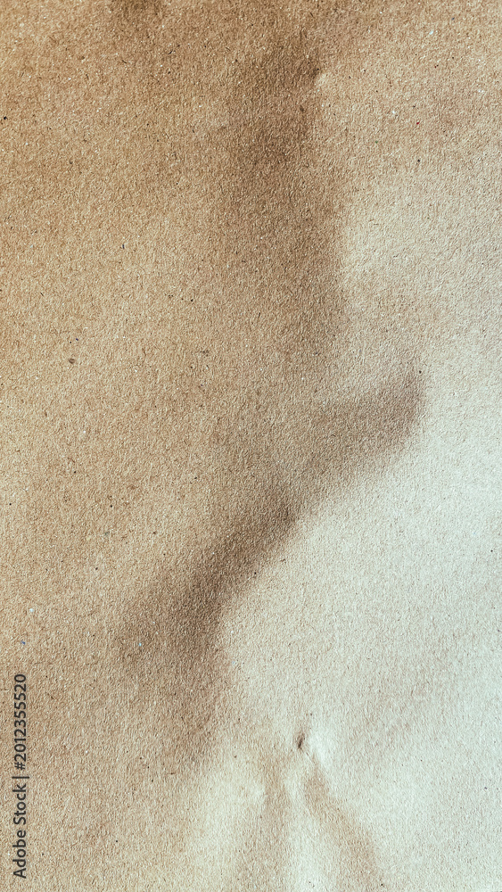 Fototapeta premium Close up of brown handmade recycled paper texture with unique organic fiber swirl pattern.