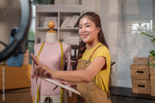 Asian woman doing live streaming selling fashion products online