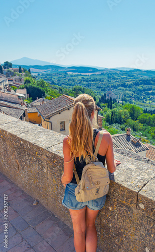 young woman traveler contemplating the timeless panorama of montepulciano