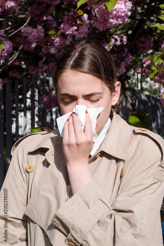 Obraz na płótnie Allergy illness with woman sneezing in park
