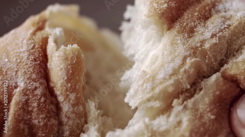 Close-up of fluffy bread rolls being pulled apart, revealing soft interior texture