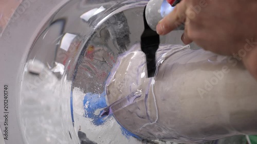 A craftsman makes a prosthetic leg for a disabled person.
