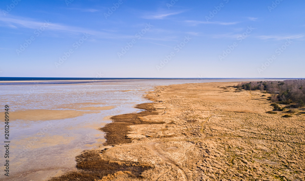Naklejka premium Ocean, landscape and nature with field for horizon, sustainable environment and space. Grassland, natural ecology and wilderness with blue sky, conservation and countryside scenery of reservation