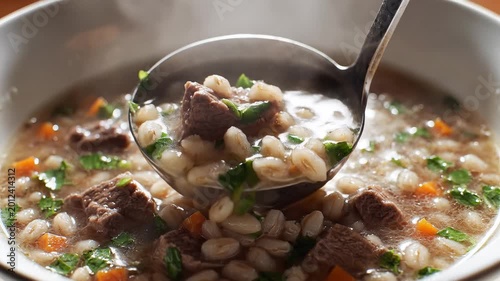 Hearty Beef and Barley Soup Being Served with a Ladle.