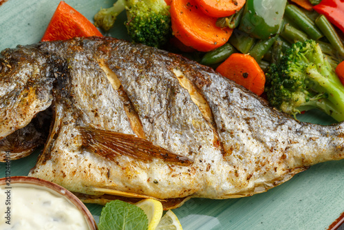 Fotografia Elegantly Plated Grilled Sea Bream Complemented By Fresh Seasonal Vegetables And
