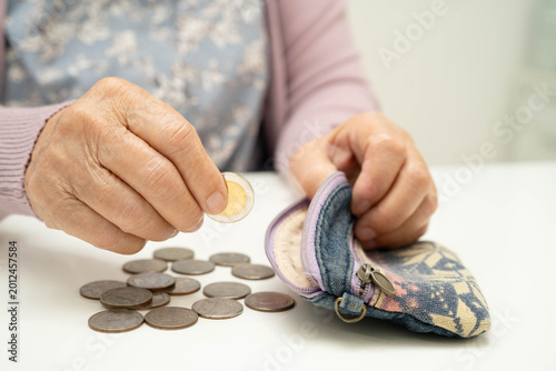 Canvas Print Asian senior or elderly old lady woman holding counting coin money in bag