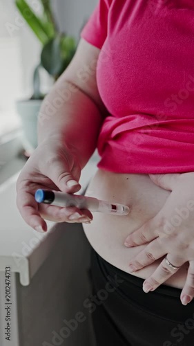 Woman with obesity making insulin shot into a belly