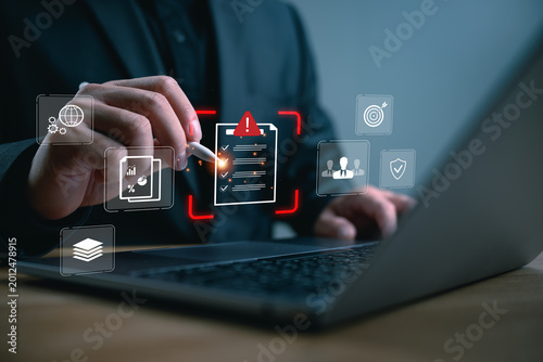 Foto Digital compliance checklist concept with businessman reviewing online documents on laptop, audit management, cybersecurity standards, risk assessment, data protection, and corporate governance