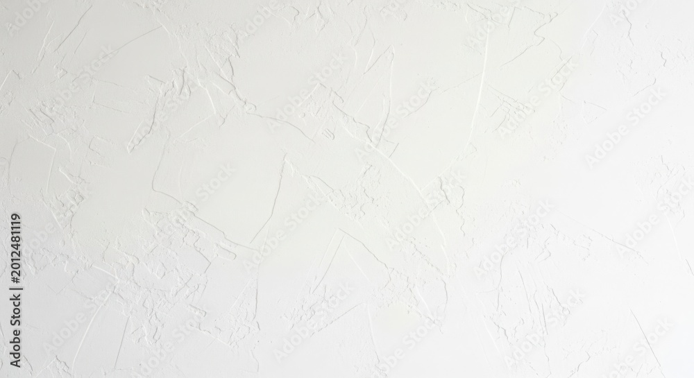 Obraz premium Textured white wall surface with subtle undulations and natural light casting soft shadows