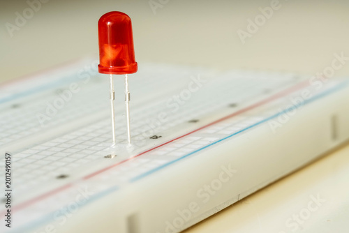 Bild auf Leinwand Red LED on breadboard close up, electronic component concept