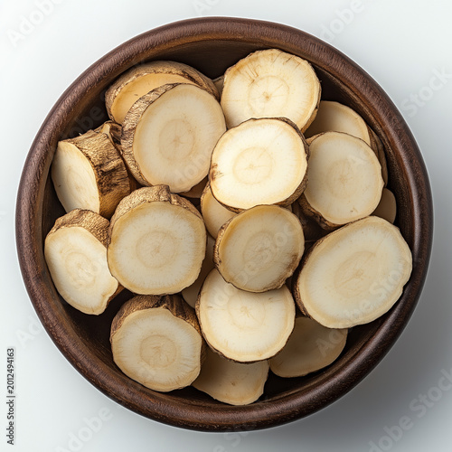 Freshly Sliced Root Vegetable in a Rustic Wooden Bowl, Top View Close-Up on White Background, Ready for Culinary Use, Natural and Wholesome Ingredient Presentation