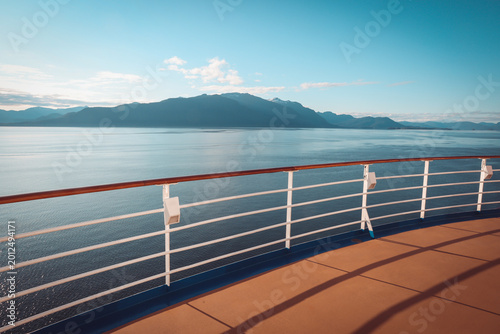Tableau sur toile view of majestic alaskan mountains and calm ocean from a luxury cruise ship deck