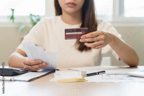 person using calculator calculating tax refund on the table