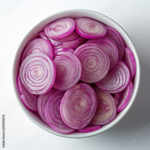 Fresh, Vibrant Red Onion Slices in a White Bowl, Top Down View, Ready for Cooking or Salad, Offering a Crisp and Flavorful Ingredient for Healthy Culinary Creations