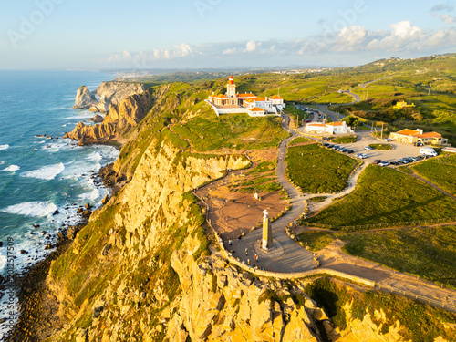 Cabo da Roca Lighthouse and Cross. Cape Roca, Cliffs and Atlantic Ocean at Sunset. Portugal. Aerial View