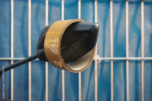Konstfotografi a roll of brown duct tape tied around a motorcycle rearview mirror against a blu