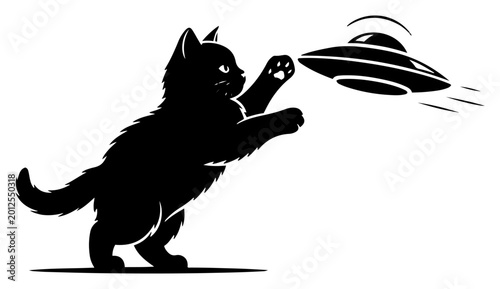 Fotografi Fluffy kitten jumping and playing with flying saucer ufo in minimalist silhouett