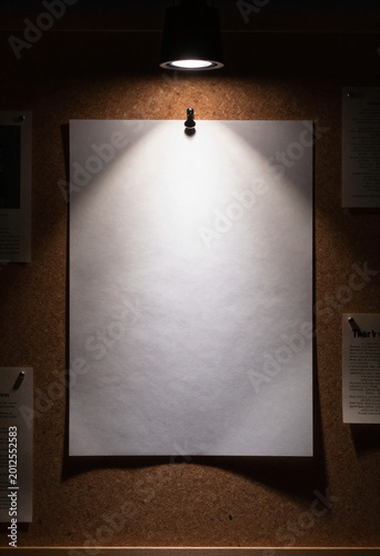 intense spotlight casts dramatic glow blank sheet paper pinned cluttered detective corkboard dimly lit room creating