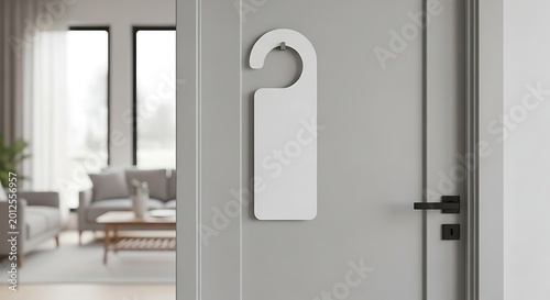 Blank white door hanger mockup on a gray door with interior background.